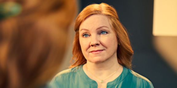 Patient listening to nurse blurred in foreground